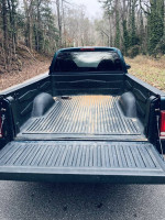 Rear view of a 1997 Dodge Dakota truck bed, featuring a bedliner and a well-maintained exterior.