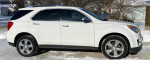 2015 Chevrolet Equinox LTZ in white, well maintained, parked in snow, featuring chrome wheels and tinted windows.