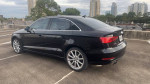 2015 Audi A3 4-Door Automatic in black with alloy wheels parked in an urban setting, showcasing its sleek design.