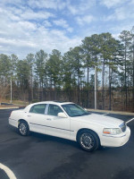 2006 Lincoln Town Car Signature RWD parked in a lot surrounded by trees, with notable recent maintenance.