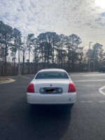 2006 Lincoln Town Car Signature RWD parked with trees in the background, showing recent upgrades and good condition.