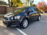 2014 Chevrolet Sonic LT 4 Door Hatchback with upgrades, aluminum wheels, and new tires parked on a street.