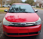 2008 Ford Focus SE coupe in Vermillion Red, low mileage, excellent condition, parked on the street.