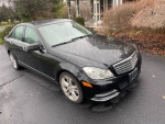 2013 Mercedes-Benz C300 4matic in black with 195,000 miles, well maintained and clean, parked on a rainy day.