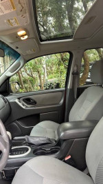 Interior view of a 2007 Ford Escape XLT with gray upholstery and panoramic sunroof.