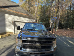 2009 Chevrolet Silverado 1500 Work Truck 4WD parked at home, showcasing its front view and shiny exterior.