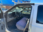 Interior view of a clean 2006 Ford F-250 truck with gray upholstery and steering wheel
