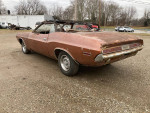 1970 Dodge Challenger convertible needing restoration, showing rear view and weathered condition.