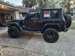 2012 Jeep Wrangler Sahara 4WD for sale, dark green with lifted aftermarket tires and soft top