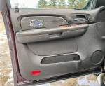 Interior door panel of a 2008 Chevrolet Silverado 1500 LTZ, featuring the Chevrolet logo and wood trim accents.