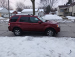 Red Ford Escape 4x4 parked on snowy street, features good tires, fully functional AC and heat, and no engine issues.