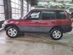Maroon low mileage Toyota RAV4 parked indoors with clean title, ready for serious buyers.