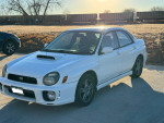 2002 Subaru Impreza WRX in white, manual transmission, parked on a driveway, 119,000 miles.