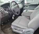 Interior view of a 2011 Ford F150 XLT with clean seats and dashboard features