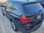 2011 BMW X3 black SUV with tinted windows parked, showcasing its sleek design and features.