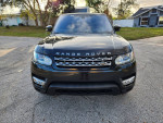 Front view of a 2017 Land Rover Range Rover HSE, black exterior, on a residential street.