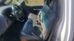 Interior view of a 2001 Ford F150 regular cab with black leather seats and steering wheel.