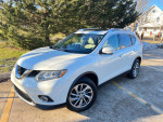White 2015 Nissan Rogue SL with low miles parked outside showcasing its sleek design and features.