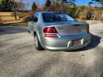 Rear view of a 2005 Dodge Stratus SXT in Satin Jade Pearl color, showcasing its sleek design.