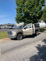 2005 Dodge Ram 1500 SLT parked in a sunny location, showcasing its all-wheel drive capability and plush interior.