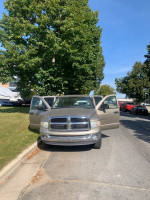 2005 Dodge Ram 1500 SLT parked with open doors, showcasing robust design and all-wheel drive features.