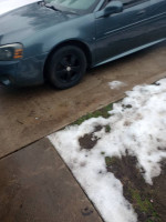 2007 Pontiac Grand Prix parked on a snowy driveway, showcasing new tires and in very good condition.