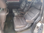 Interior view of a Honda Odyssey showcasing leather seating and spacious design, well-maintained with low mileage.