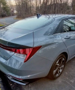 Rear view of a 2021 Hyundai Elantra Limited in Electric Shadow color, showcasing its sleek design and modern features.