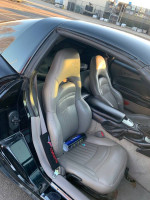 Interior of a Chevrolet Corvette with leather seats and custom features, showcasing an excellent condition.