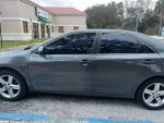 2013 Hyundai Sonata SE with tinted windows parked outside a building, showcasing its sleek design and good condition.