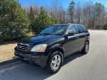 2009 Kia Sorento SUV with 121k miles, well-maintained with new tires, parked outdoors