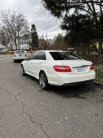 2010 Mercedes-Benz E-Class E550 sedan parked on street, showcasing its elegant design and high-performance features.