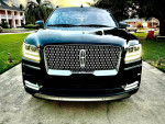 Front view of a 2018 Lincoln Navigator Black Label 4WD parked outside, showcasing its pristine finish and modern design.