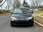 2013 Honda Odyssey EX FWD in black parked on a residential street, featuring a clean exterior and ready for sale.