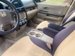 Interior view of a 2006 Honda CR-V LX, featuring clean seats and functional controls.