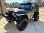 2006 Jeep Wrangler with 4.0L engine, manual transmission, and 35-inch tires parked in driveway