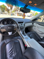 Interior view of a 2011 Cadillac CTS showing black leather seats and dashboard features.