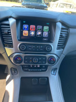 Interior dashboard of 2017 Chev Tahoe LT showing controls and screen, in good condition with modern features.