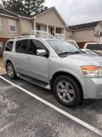 2011 Nissan Armada Platinum edition parked, featuring heated seats and spacious interior, ideal for long trips.