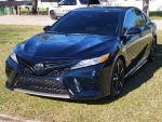 2020 Toyota Camry XSE in Galactic Aqua with panoramic roof and leather seat covers parked in grass
