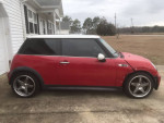 2005 MINI Cooper S in red with aftermarket wheels and modifications, parked outdoors.