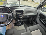 Interior view of a 2010 Ford Ranger XLT showing dashboard and steering wheel details.