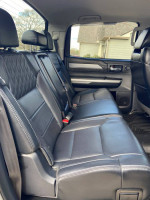 Interior of 2014 Toyota Tundra Platinum showcasing black leather rear seats with spacious design