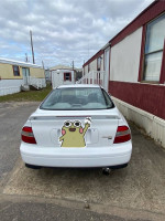 1994 Honda Accord project car with 101,000 miles, showing a clean white exterior and minor bumper crack.