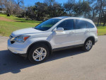 2011 Honda CR-V EX-L in white, showcasing sleek design and clean condition on a sunny day