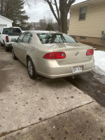 2009 Buick Lucerne CXL FWD parked in residential driveway with winter landscape