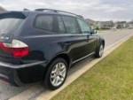 2007 BMW X3 parked on the street with 126,271 miles, showcasing sleek design and luxury features.