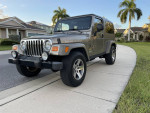 2005 Jeep Wrangler Rubicon Unlimited in Light Khaki Metallic on a residential street