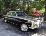 1973 Rolls-Royce Silver Shadow saloon in two-tone silver and black, parked among blooming flowers.