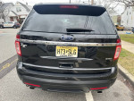 Rear view of a black 2014 Ford Explorer XLT FWD with license plate, showcasing its sleek design and features.